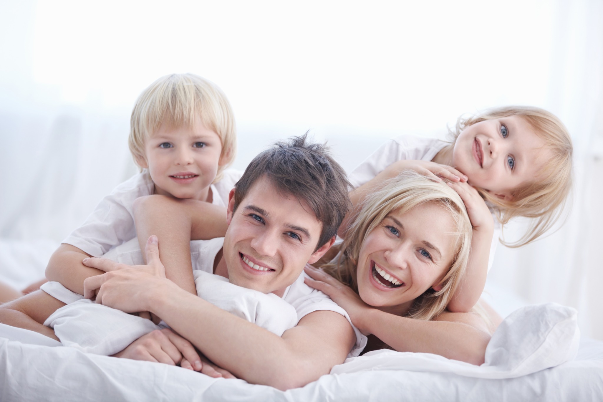 Happy family relaxing on a bed